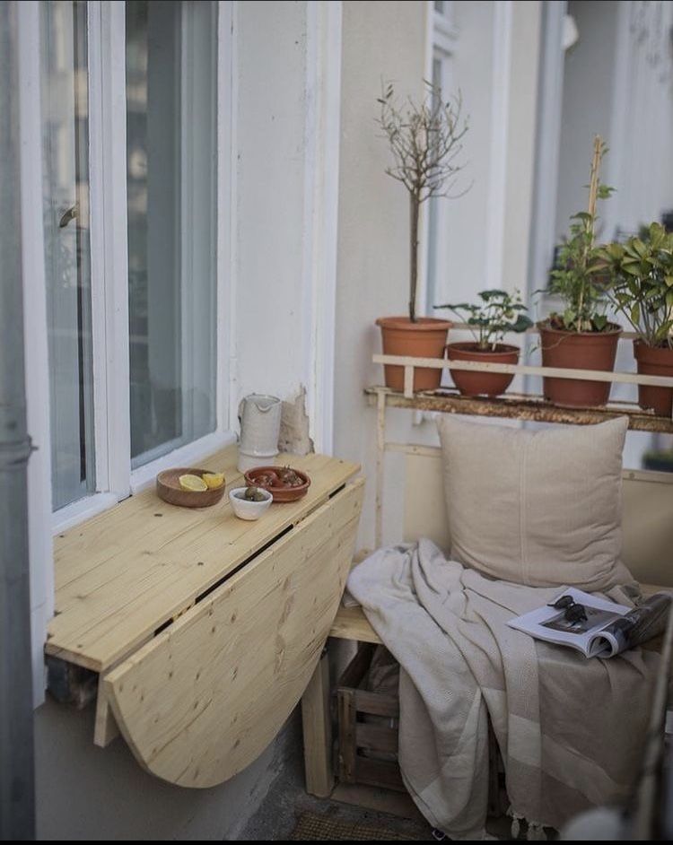Small apartment balcony with compact space-saving furniture and chairs
