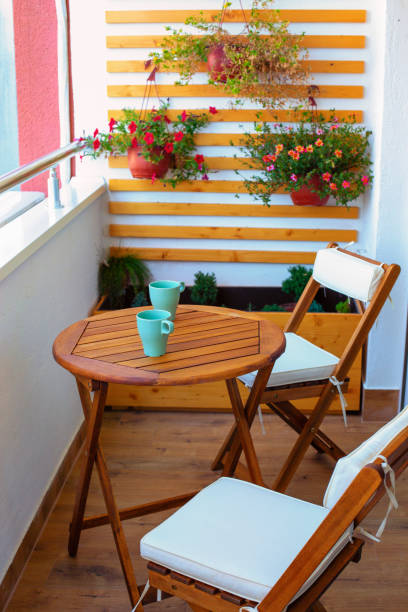 Small balcony with simple seating arrangement and plants