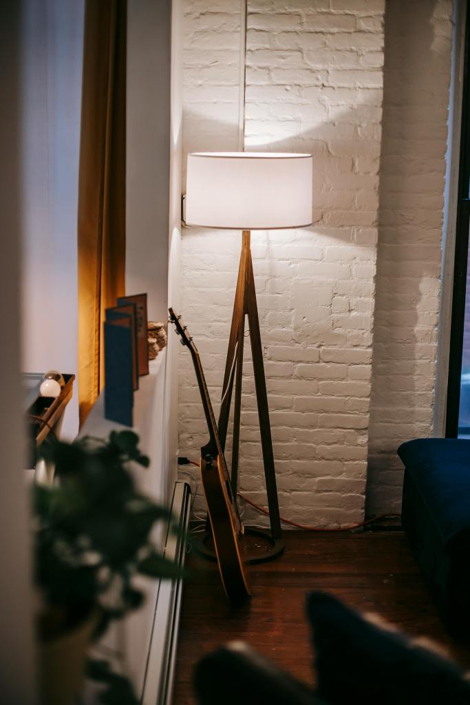 Warm layered lighting making a small apartment feel larger and more elevated