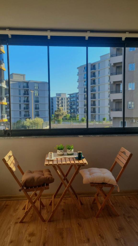 small apartment balcony with simple folding chair seating setup